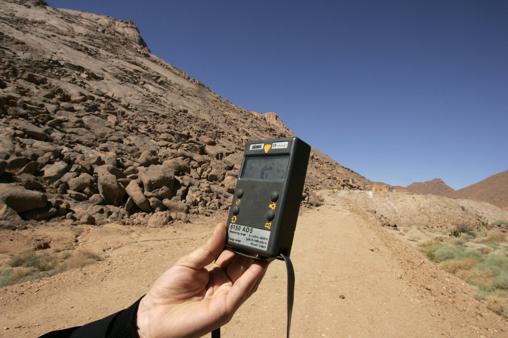 Geiger counter measures atom radiation at French nuclear tests' site in In-Ekker near Ain Maguel